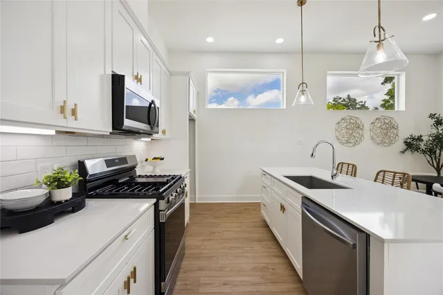 a kitchen with a sink stove and microwave