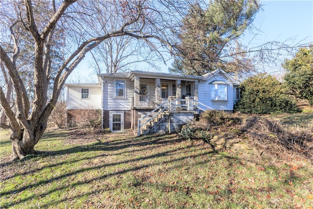 4267 Glen Eden Road Cranberry Township, PA 16066 - Photo 2 of 25 a front view of a house with a yard table and chairs