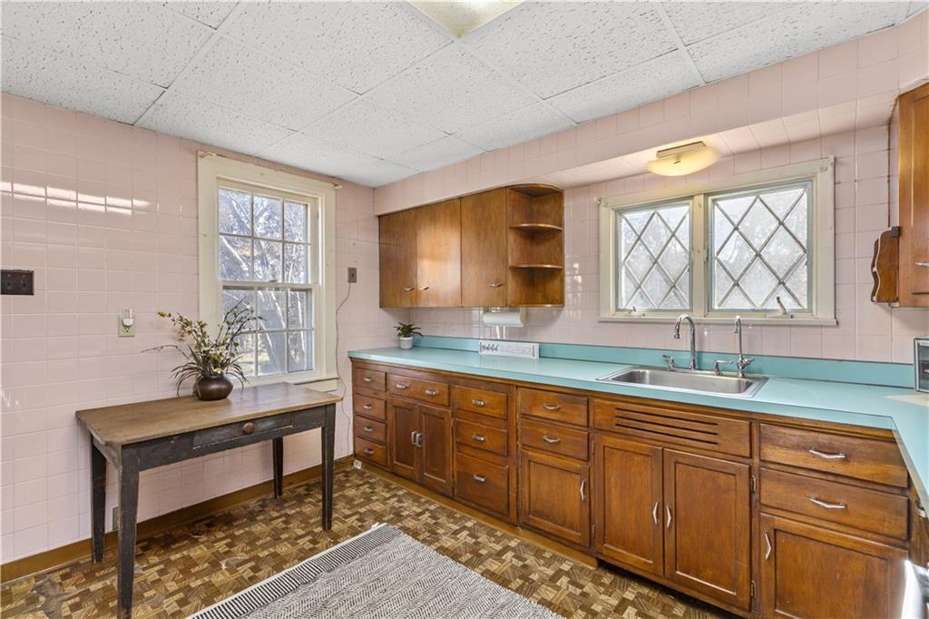 4267 Glen Eden Road Cranberry Township, PA 16066 - Photo 4 of 25 a kitchen with granite countertop wooden cabinets a sink dishwasher a dining table and chairs with wooden floor