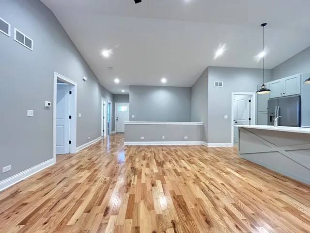 a large room with kitchen view and a sink