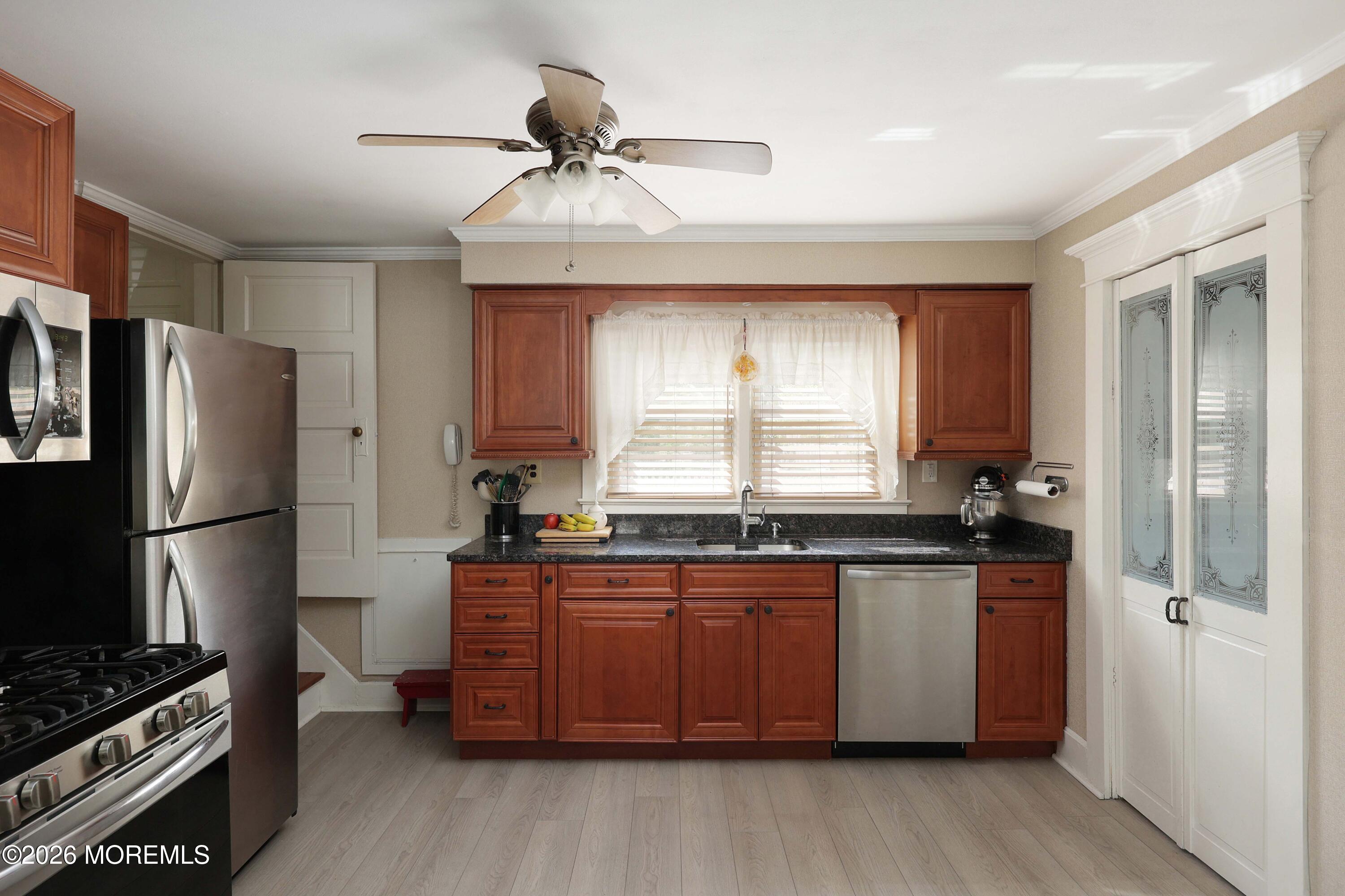 715 Howe Street Point Pleasant, NJ 08742 - Photo 13 of 45 a kitchen with granite countertop a sink stainless steel appliances and cabinets