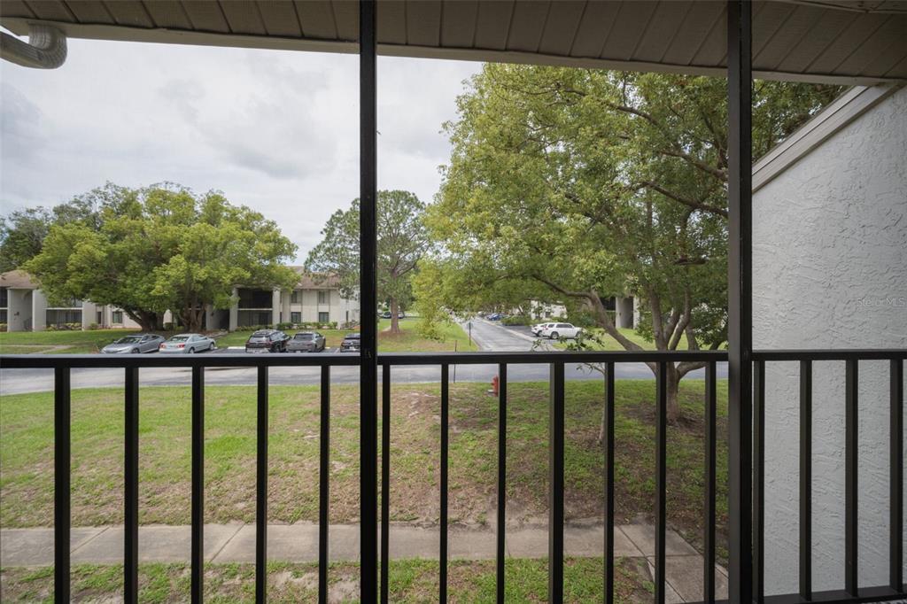 2687 Pine Ridge Way South, Unit B2 Palm Harbor, FL 34684 - Photo 29 of 68 a view of a balcony with a floor to ceiling window next to a yard