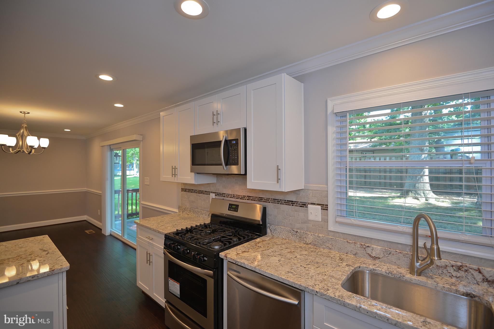 208 Acadia Road Waldorf, MD 20602 - Photo 8 of 29 Kitchen with white cabinets and new granite