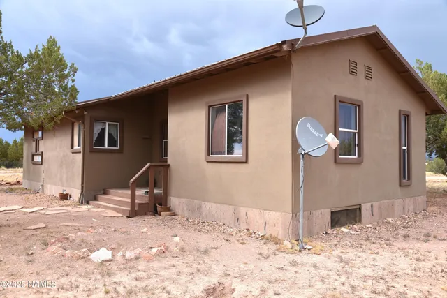 a view of backyard with large trees