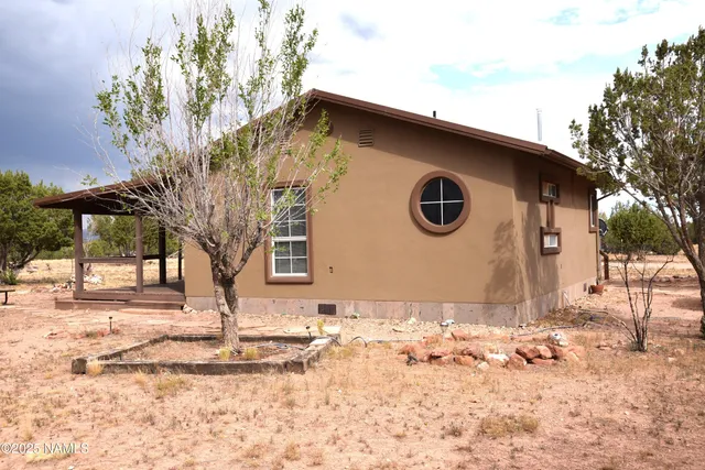 a living room with furniture a dining table and a fireplace