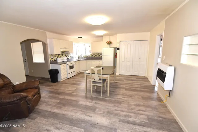 a kitchen with a refrigerator and a stove top oven