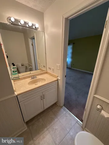 a bathroom with a double vanity sink and mirror