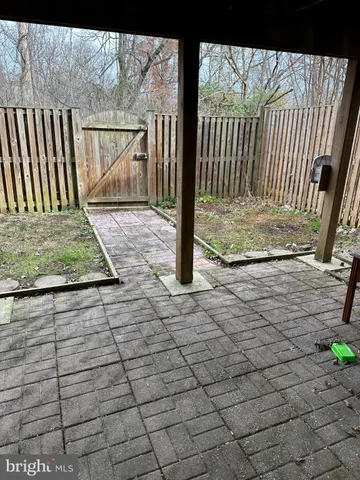 a view of a patio with table and chairs