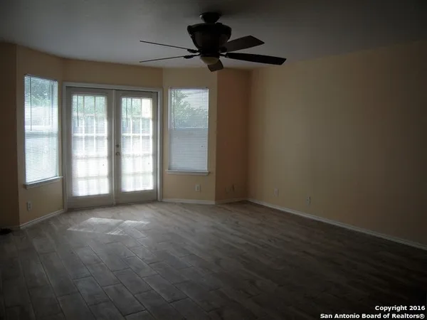 a view of a livingroom with a ceiling fan and window