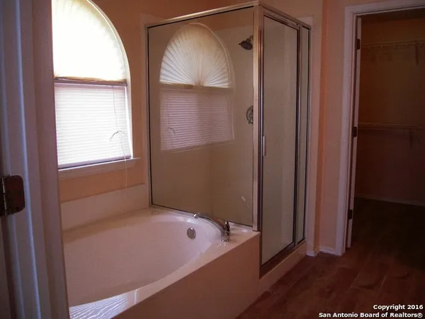 a bathroom with a tub and shower