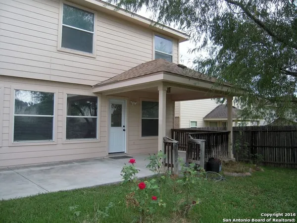 a front view of a house with a porch and a table