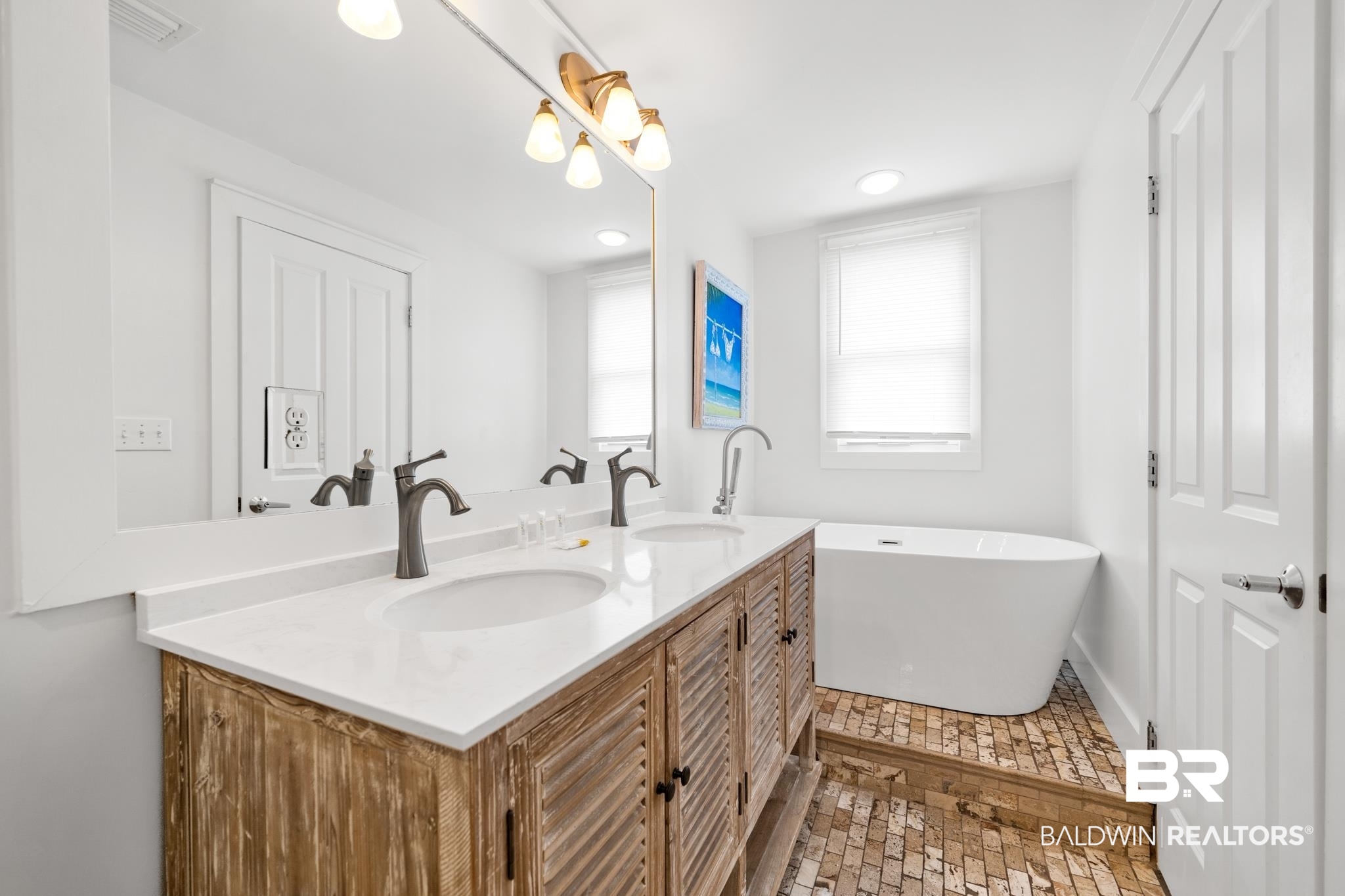 815 Plantation Road, Unit 301 Gulf Shores, AL 36542 - Photo 14 of 29 Full bath featuring a freestanding bath, a sink, double vanity, and visible vents