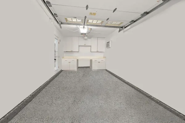 a view of a kitchen with a sink and dishwasher a refrigerator with white cabinets