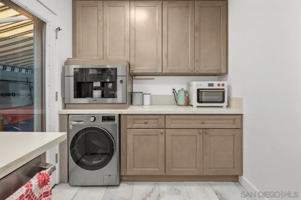 a utility room with sink dryer and washer