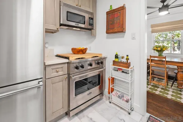 a kitchen with stainless steel appliances granite countertop a stove and a microwave