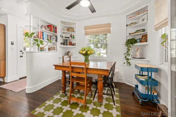 a dining room with furniture and wooden floor