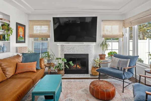 a living room with furniture a flat screen tv and a fireplace