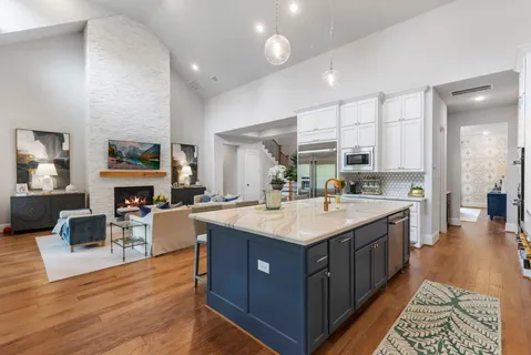 a kitchen with stainless steel appliances a sink stove and cabinets