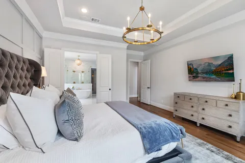 a large bathroom with a double vanity sink a large mirror and a bathtub