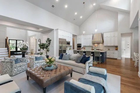 a living room with furniture and view of kitchen