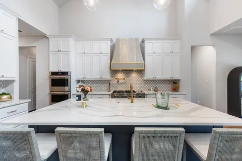 a kitchen with stainless steel appliances a sink a stove and a refrigerator