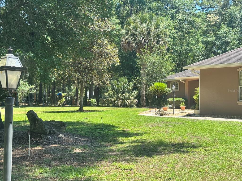 11145 Northwest 17th Court Road Ocala, FL 34475 - Photo 16 of 59 a view of a house with a yard and sitting area