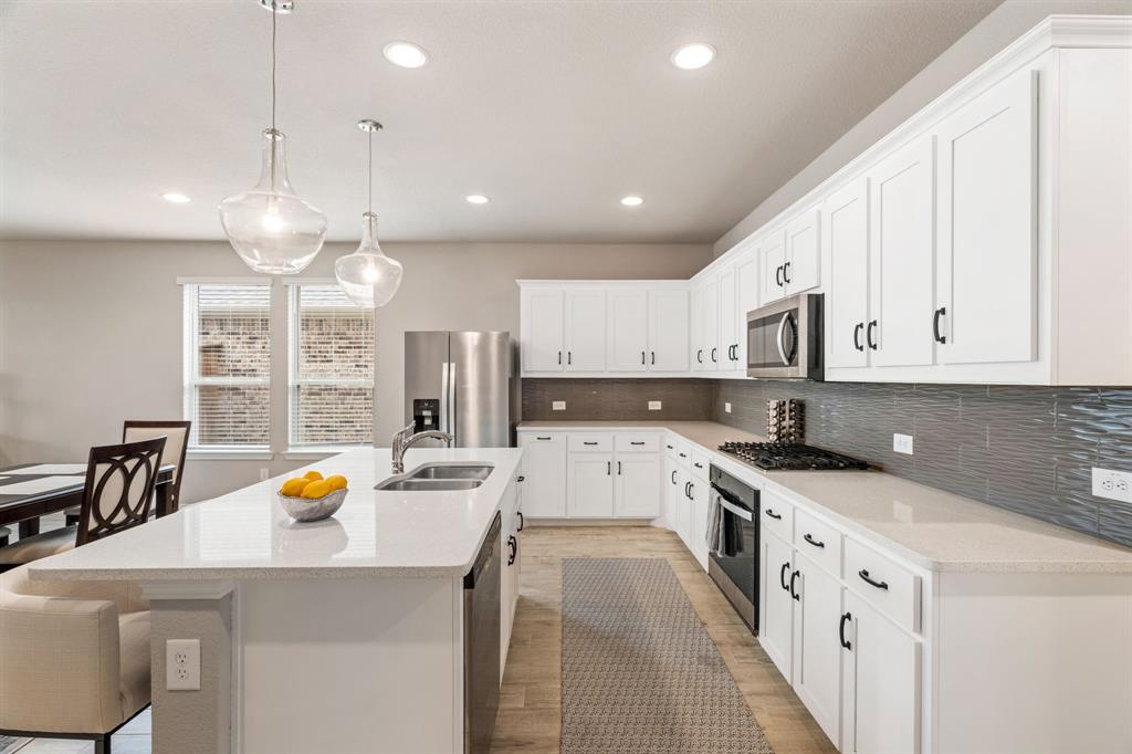 321 Pasture Drive Midlothian, TX 76065 - Photo 10 of 40 a kitchen with stainless steel appliances granite countertop a sink stove and cabinets