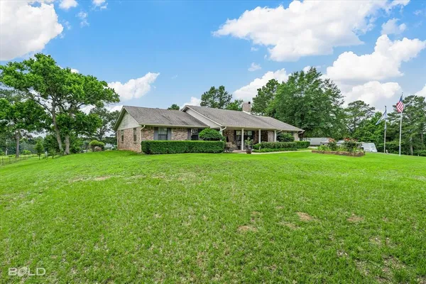 a view of an house with backyard space and balcony