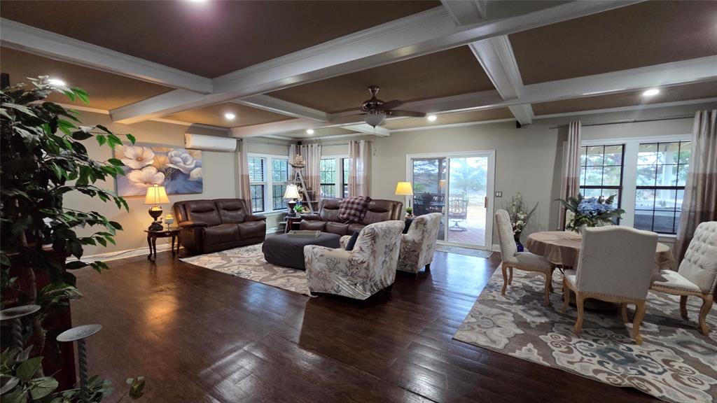 236 Charlie Cannon Road Coushatta, LA 71019 - Photo 19 of 39 Living area featuring beamed ceiling, dark wood finished floors, coffered ceiling, ceiling fan, and a wall mounted air conditioner