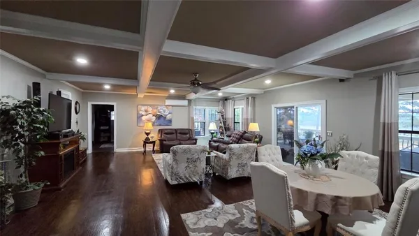 a living room with lots of furniture and potted plants