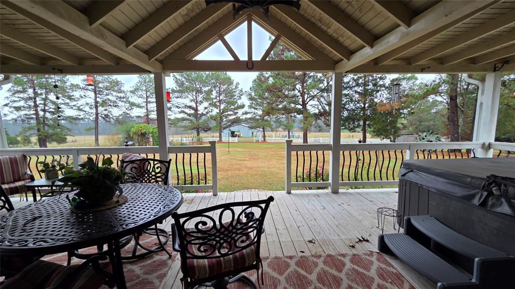 236 Charlie Cannon Road Coushatta, LA 71019 - Photo 21 of 39 Wooden deck with a yard, a hot tub, and outdoor dining space