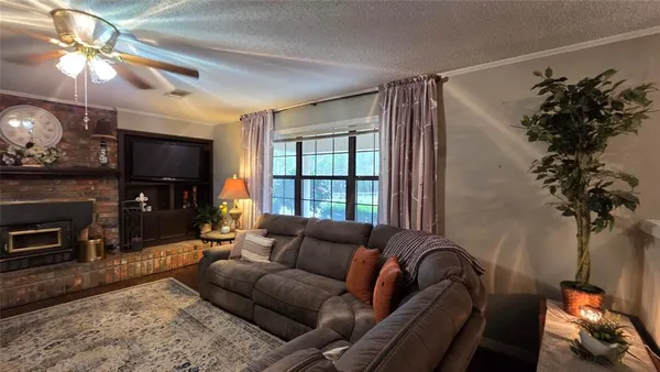 a living room with furniture a window and a chandelier