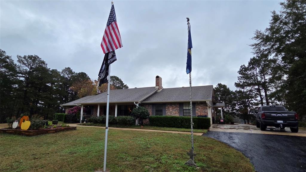 236 Charlie Cannon Road Coushatta, LA 71019 - Photo 38 of 39 Ranch-style house with a front lawn, a chimney, asphalt driveway, and brick siding