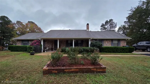 a front view of a house with a yard and porch