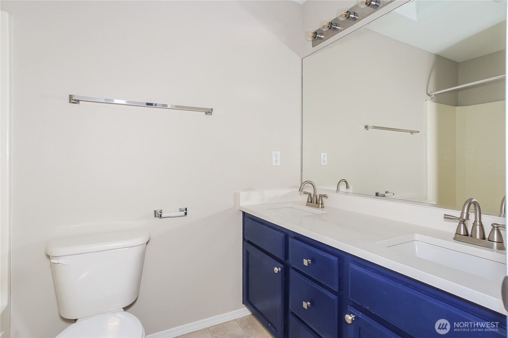 9002 161st Street East Puyallup, WA 98375 - Photo 11 of 17 a bathroom with a toilet sink and mirror