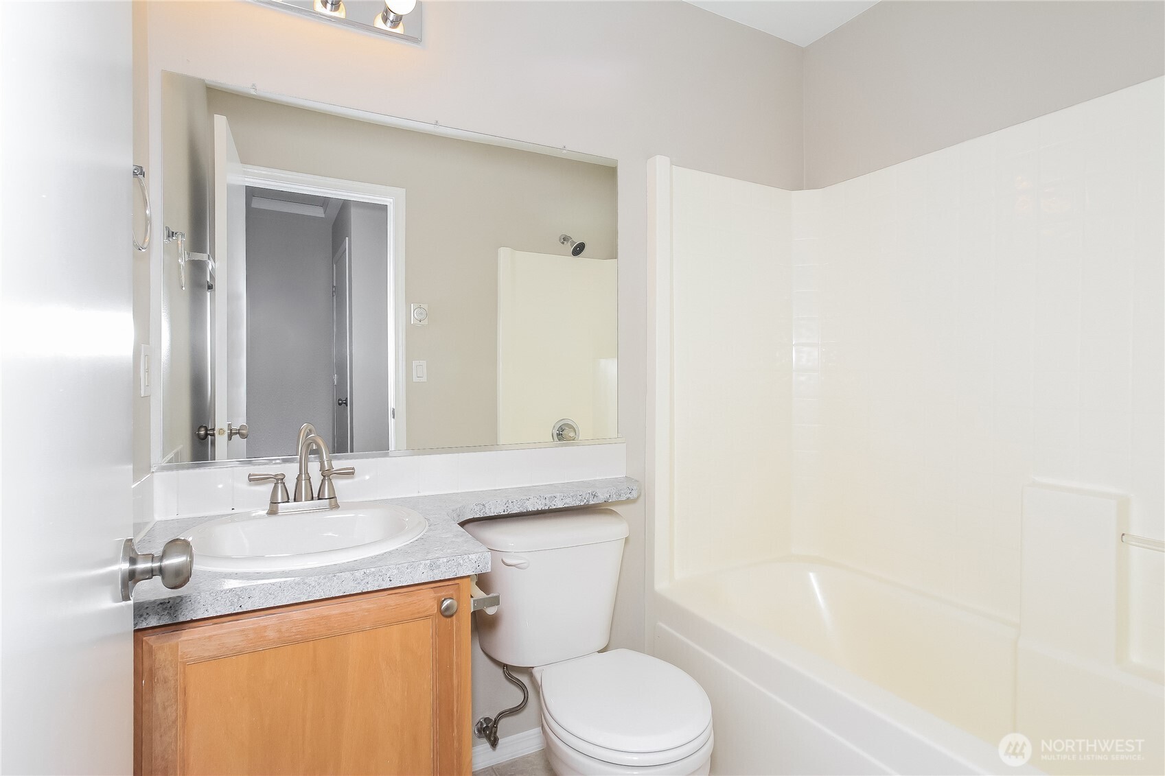 9002 161st Street East Puyallup, WA 98375 - Photo 12 of 17 a bathroom with a granite countertop sink toilet and shower