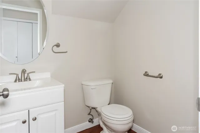 a bathroom with a sink a toilet and a mirror