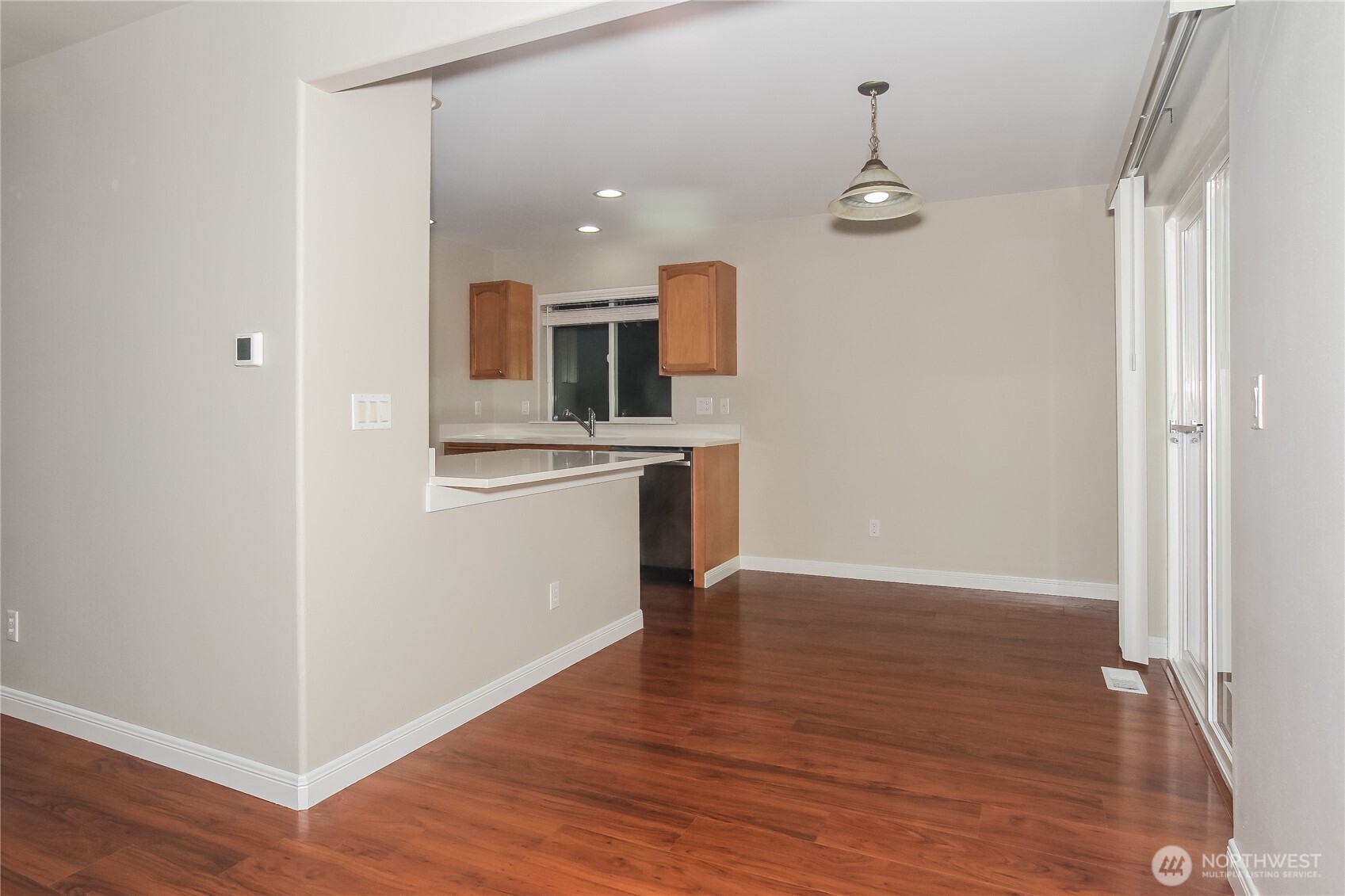 9002 161st Street East Puyallup, WA 98375 - Photo 4 of 17 a view of a kitchen with a sink and wooden floor