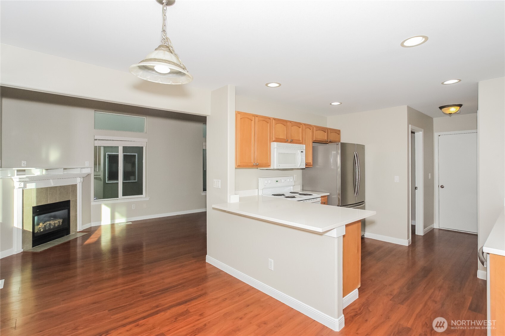 9002 161st Street East Puyallup, WA 98375 - Photo 5 of 17 a kitchen with stainless steel appliances granite countertop a sink stove and wooden floor