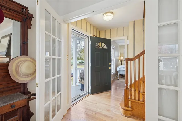 a view of a livingroom with wooden floor and staircase