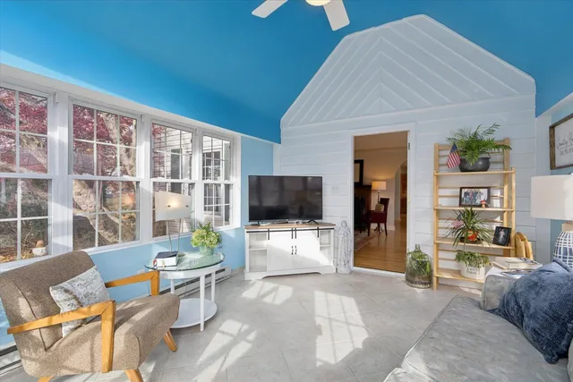a living room with furniture and floor to ceiling windows