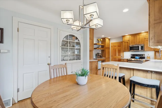 a kitchen with stainless steel appliances granite countertop a sink a stove and a refrigerator