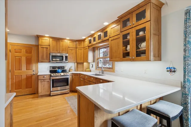 a large kitchen with stainless steel appliances granite countertop a sink and cabinets