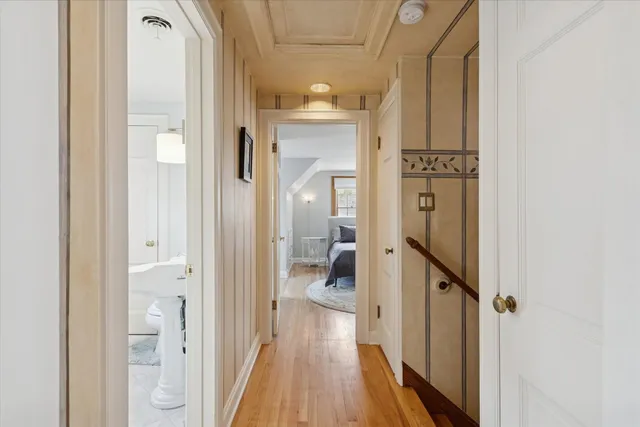 a bedroom with a large bed closet and a chandelier