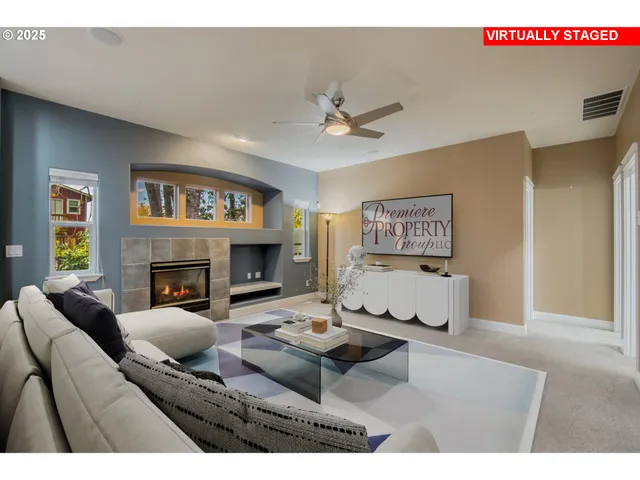 a view of a livingroom with a fireplace and a ceiling fan