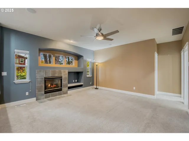 a view of a livingroom with a kitchen and a fireplace