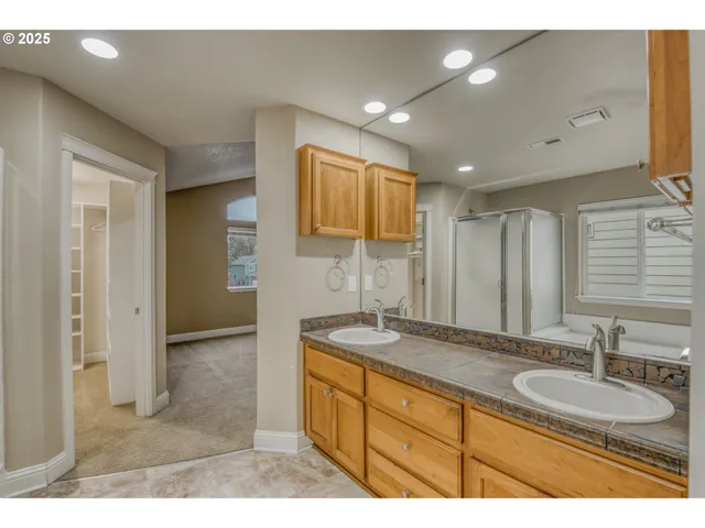 a bathroom with a sink double vanity granite and a mirror
