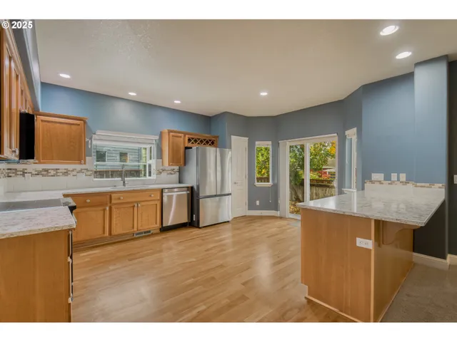 a open kitchen with granite countertop a sink and dishwasher with a large window