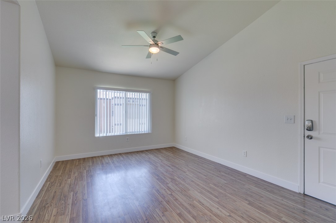 6650 West Warm Springs Road, Unit 2118 Las Vegas, NV 89118 - Photo 25 of 41 A well-lit living area features an elegant vaulted ceiling and wood-look flooring.