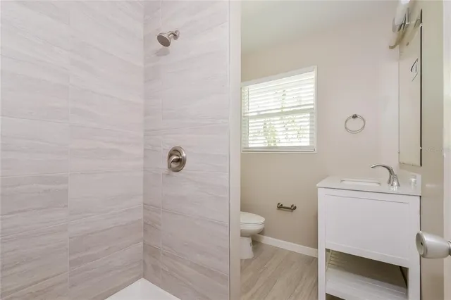 a bathroom with a sink toilet and shower